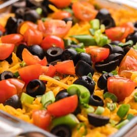 angled shot of taco dip in glass dish