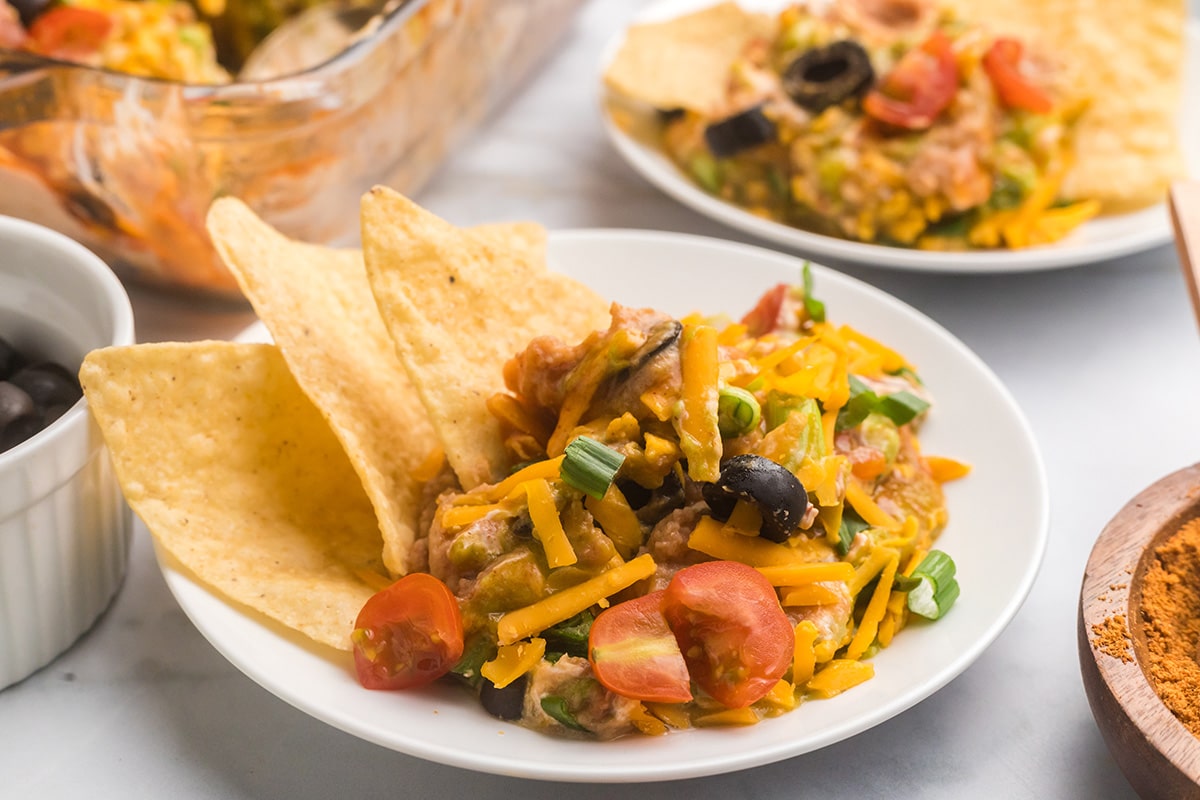 7 layer dip on a plate with chips