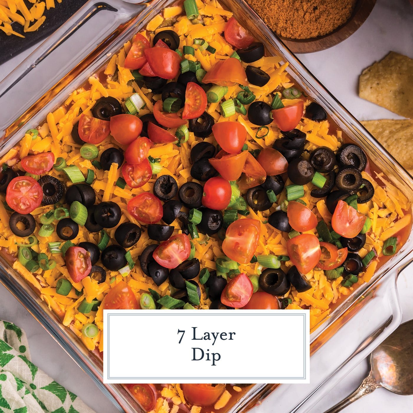 overhead shot of 7 layer dip with text overlay for facebook