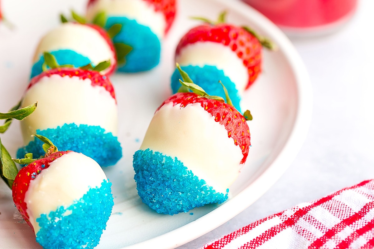 close up of all american strawberries on a plate