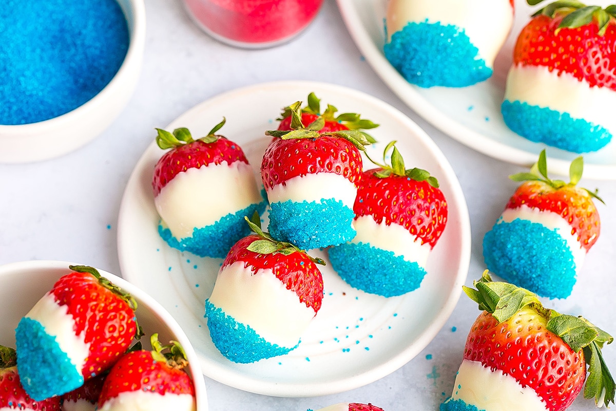 overhead shot of plate of red white and blue chocolate covered strawberries