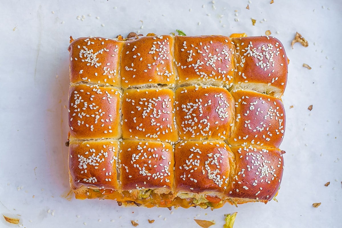 sesame seeds sprinkled onto slider buns