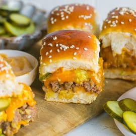 pickles and big mac sliders on a cutting board