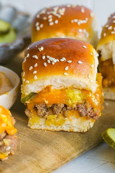 pickles and big mac sliders on a cutting board