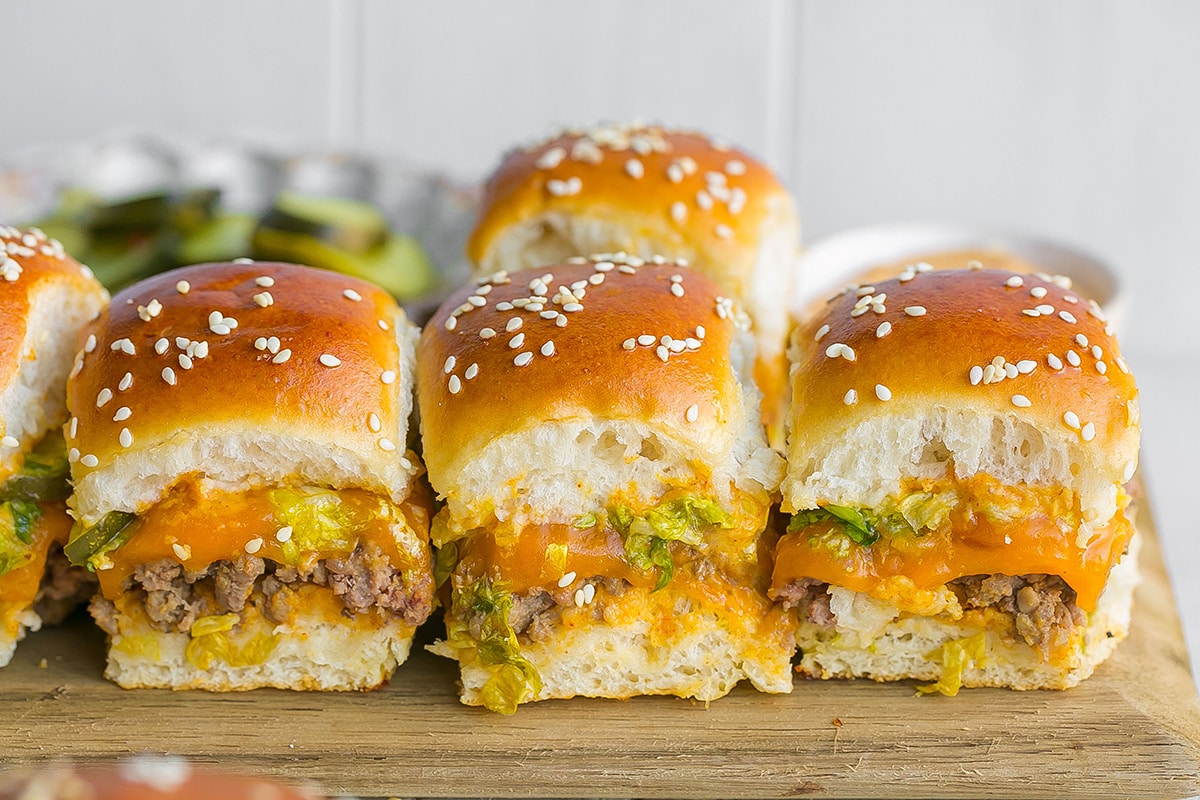 straight on shot of three big mac sliders on a cutting board