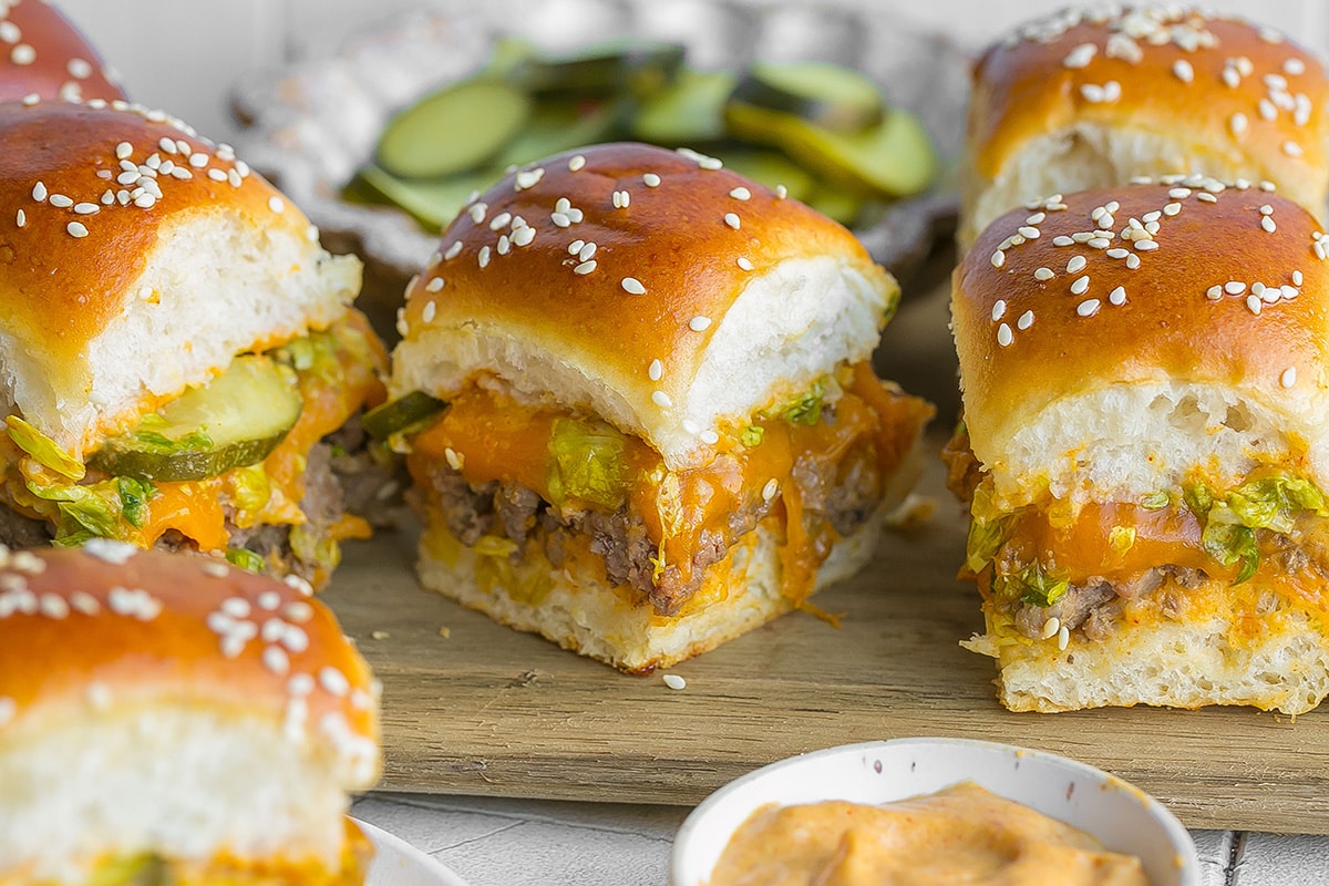 three big mac sliders on cutting board