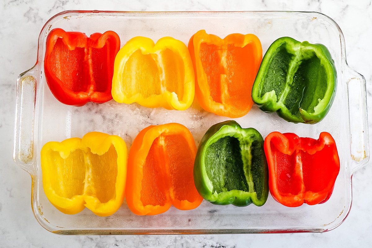 halved peppers in a baking dish