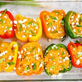 buffalo chicken stuffed peppers in a baking dish