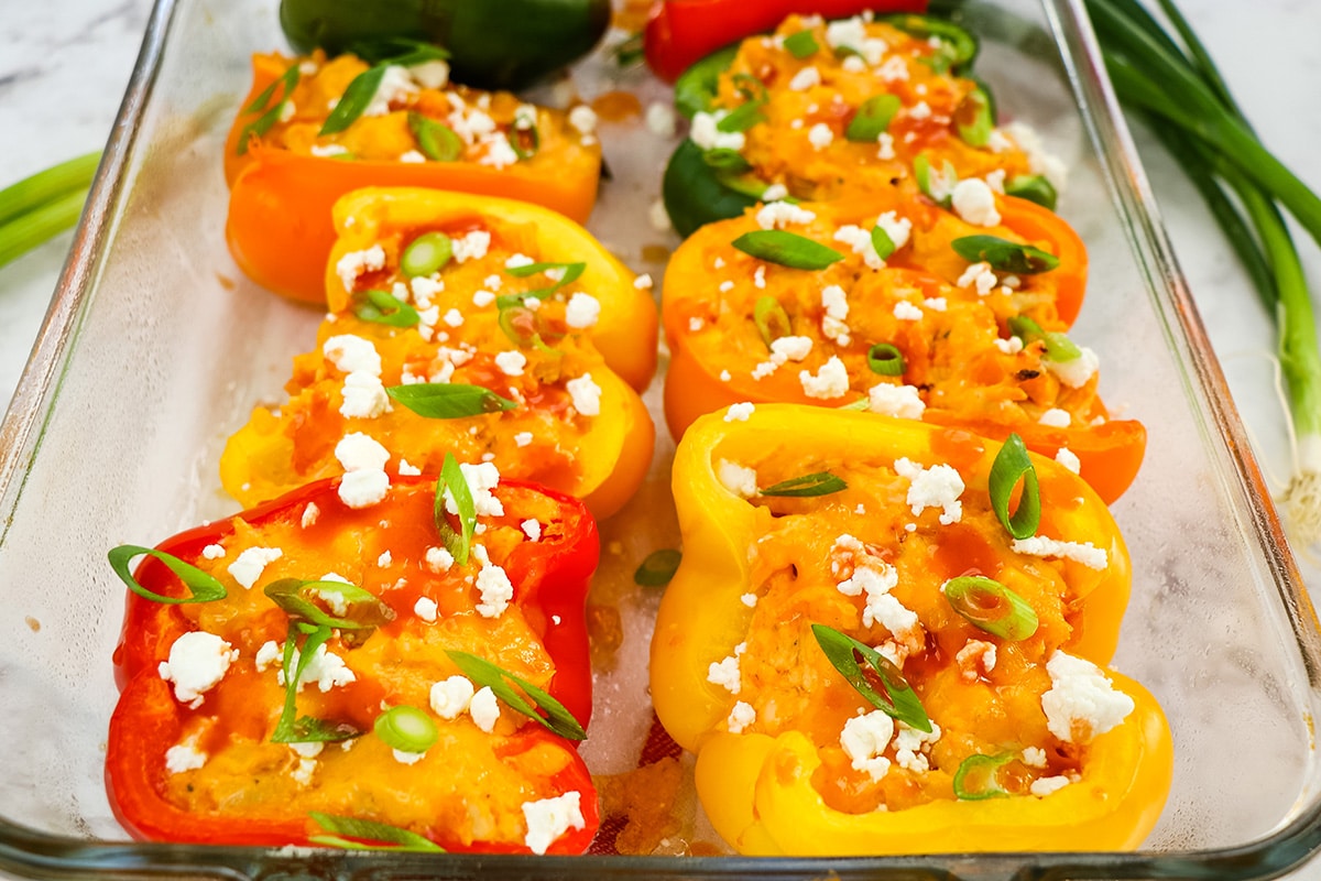 close up of stuffed peppers in a baking dish