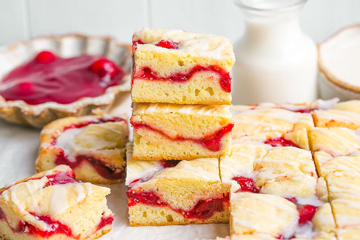 stack of cherry pie bars with filling in the background