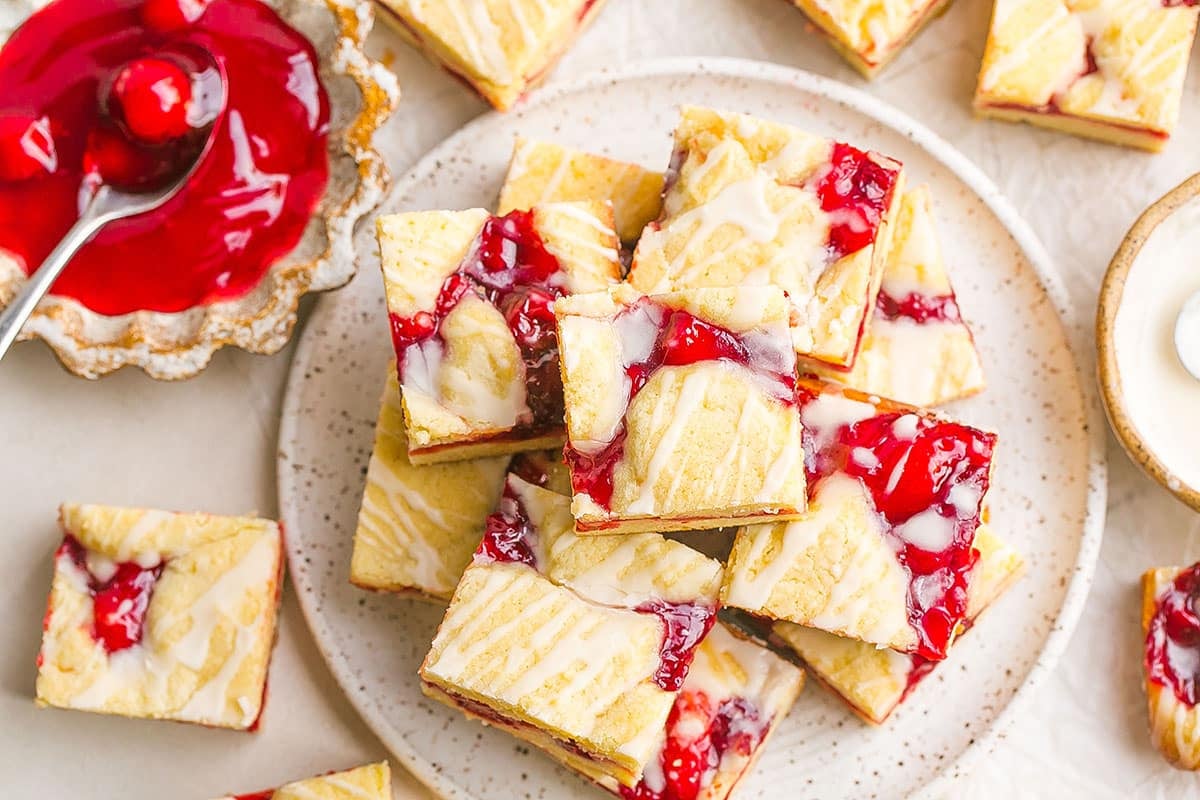 cherry pie bars on a white speckled plate