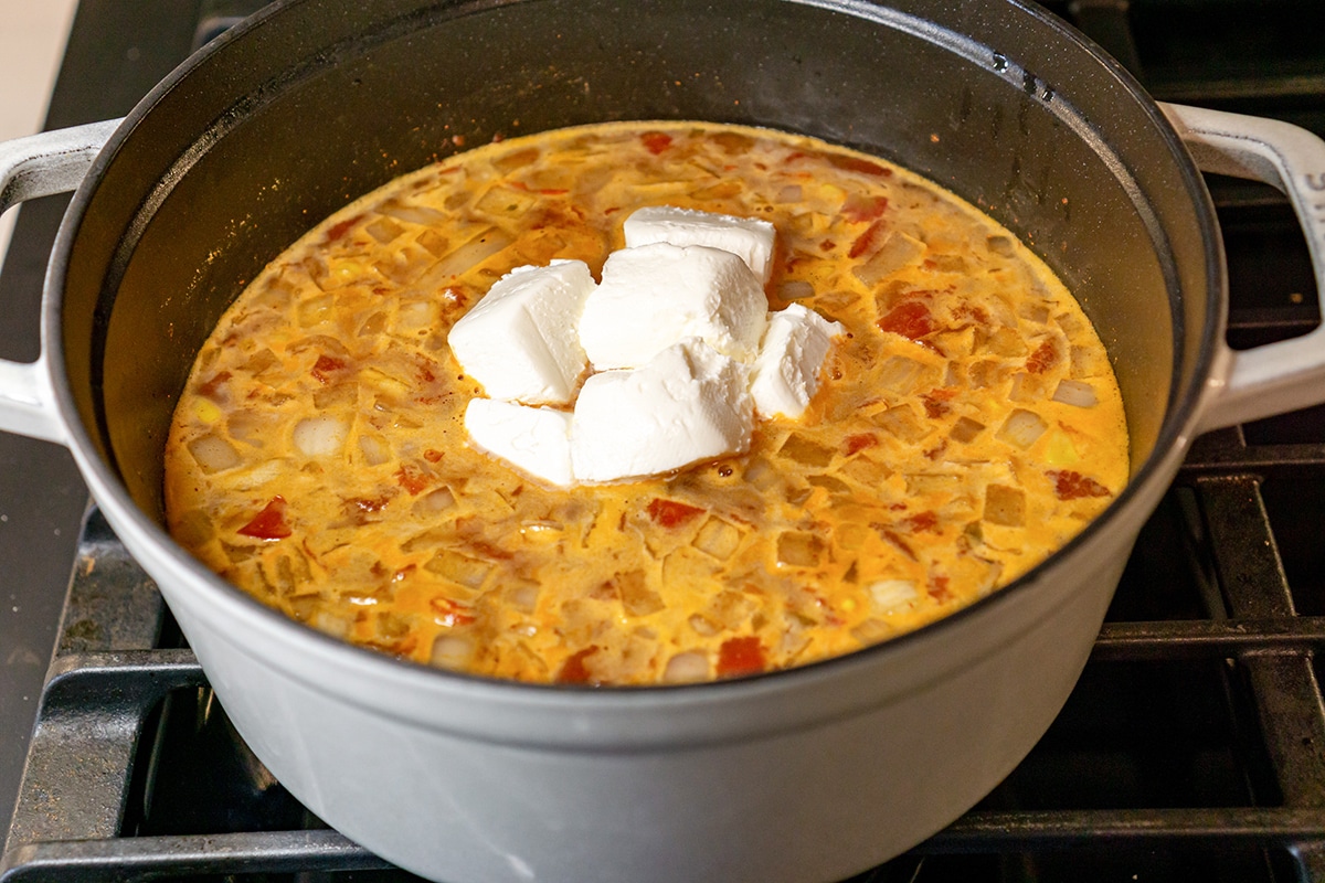 cream cheese added to soup in pot