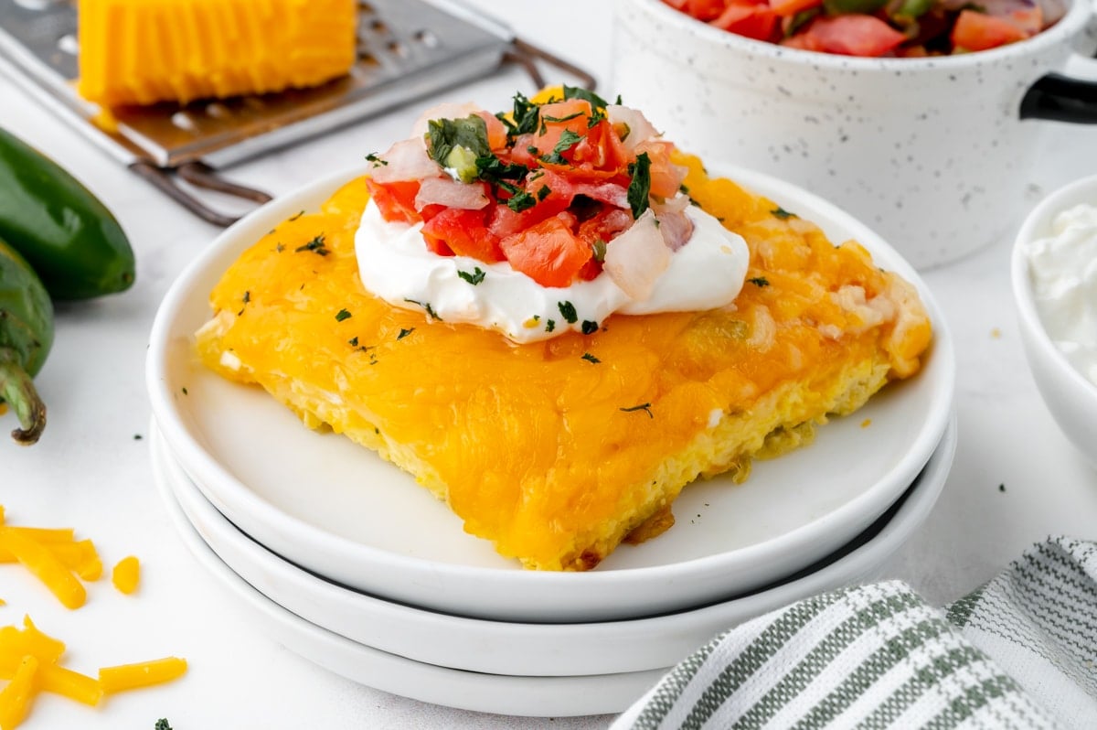 angle slice of breakfast casserole with pico and sour cream