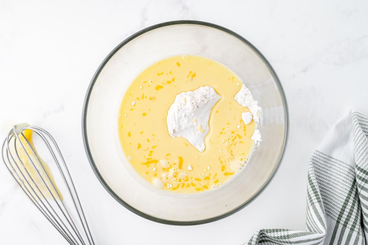 egg mixture with flour in a clear mixing bowl