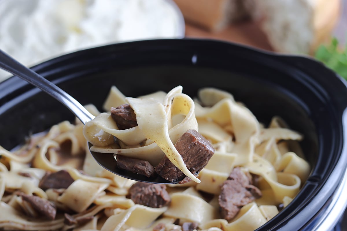 close up of beef and noodles on a fork