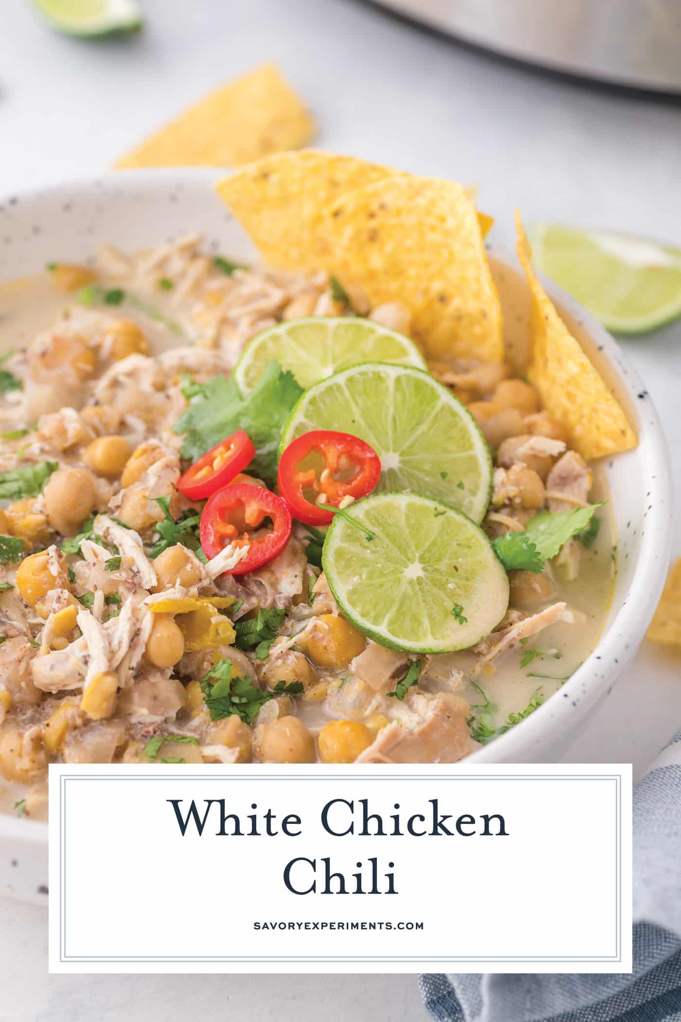 half a shot of white chicken chili in a bowl with text overlay for pinterest
