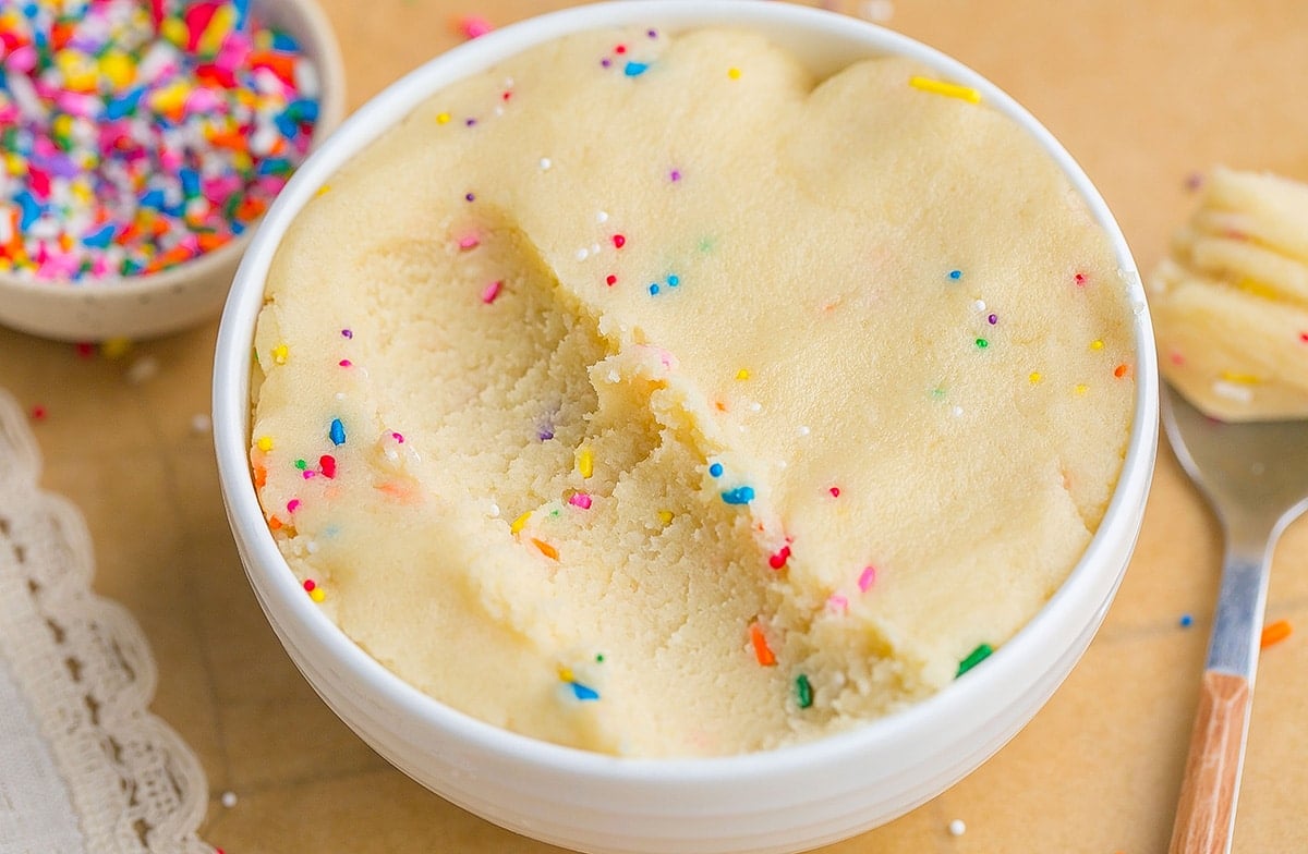 scoop taken out of bowl of sugar cookie dough