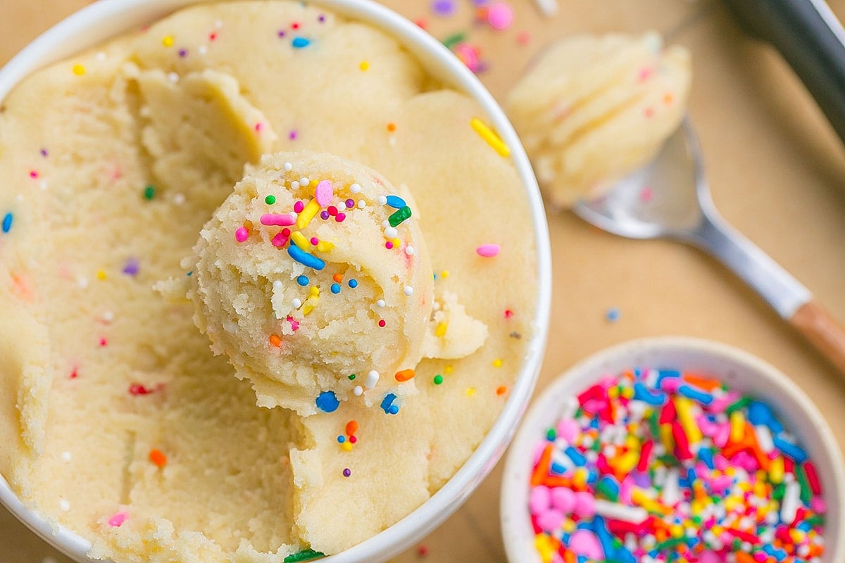 overhead shot of bowl of cookie dough with scoop on it