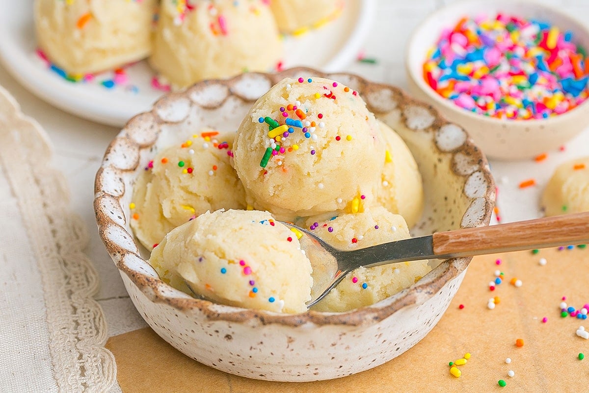 spoon in bowl of sugar cookie dough