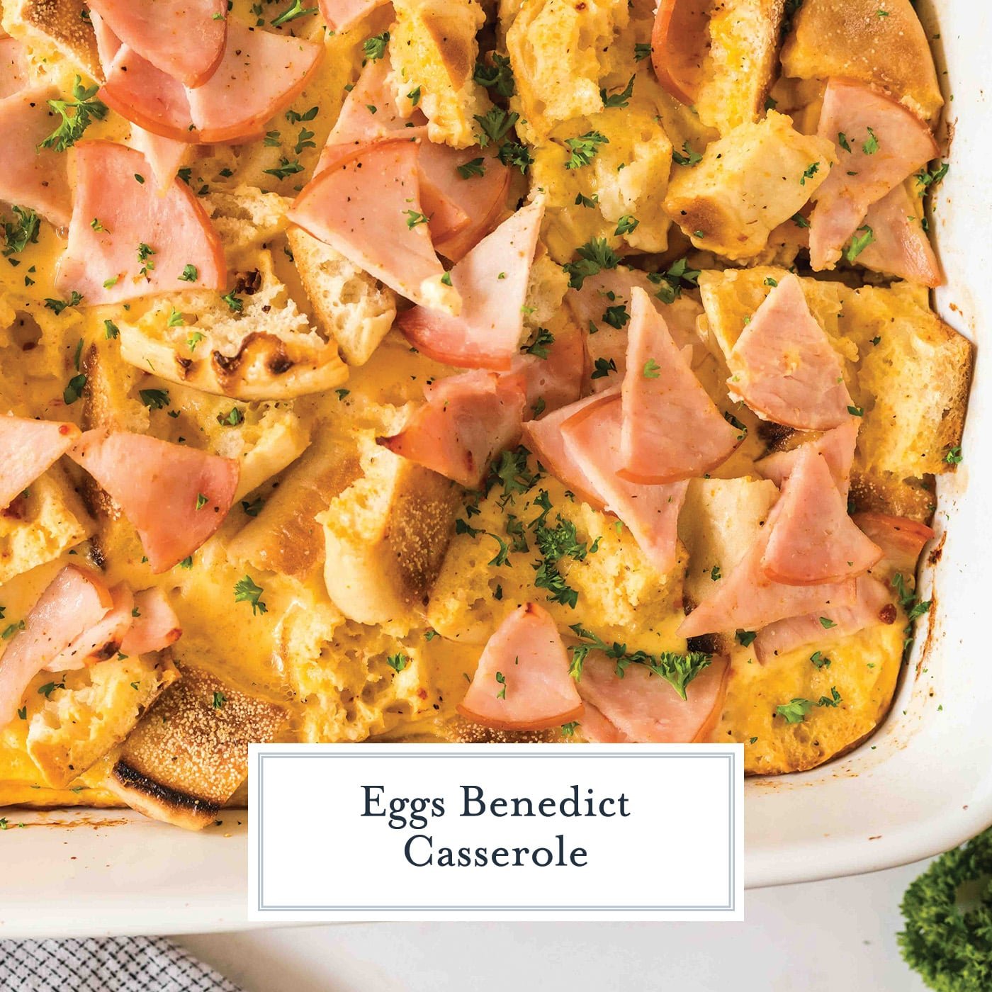 overhead shot of baked eggs benedict casserole with text overlay for facebook