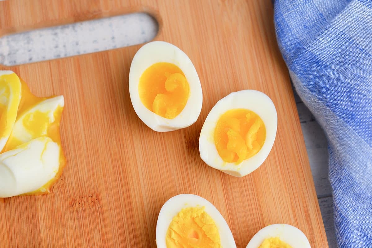 four minute eggs on a wood cutting board