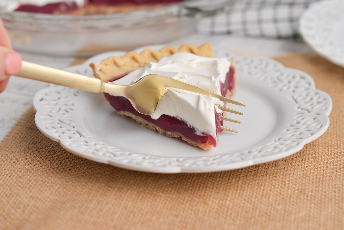 fork taking bite of grape juice pie