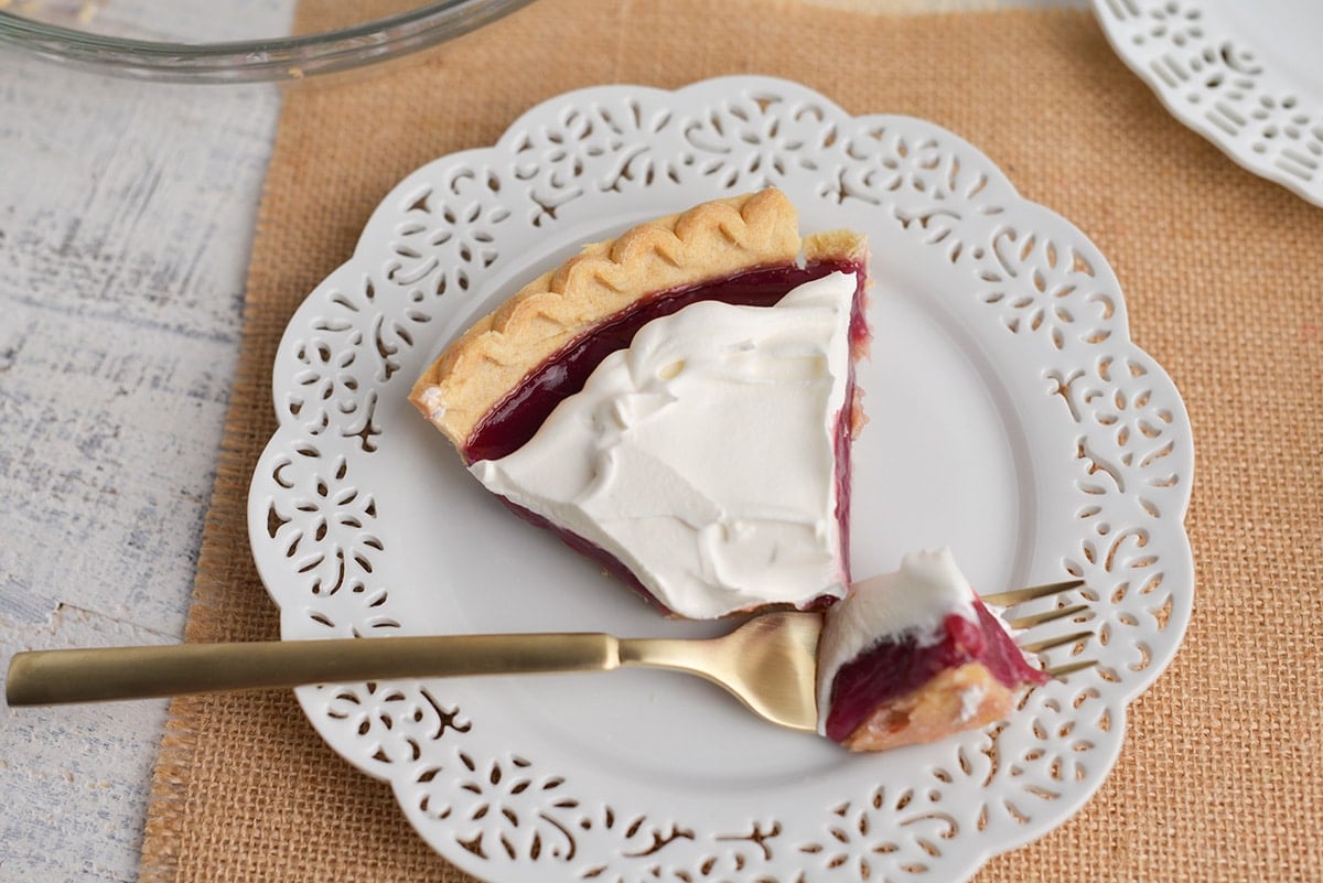 fork with bite of grape juice pie slice