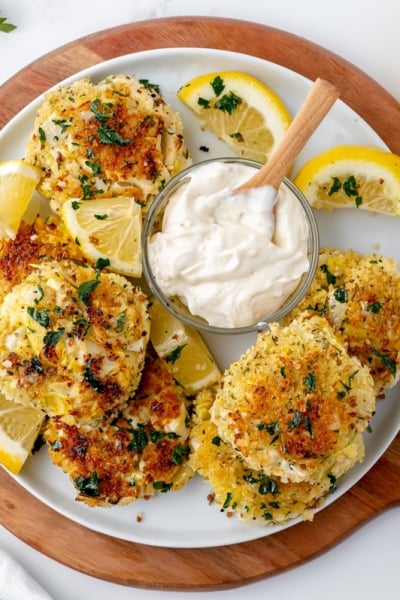 overhead shot of hearts of palm cakes on a platter with dipping sauce