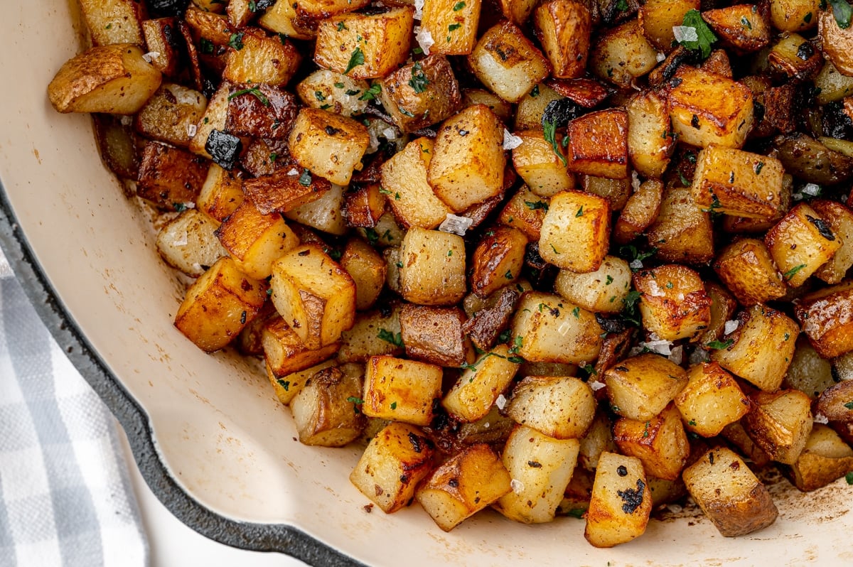 overhead of fried potatoes with parsley and salt