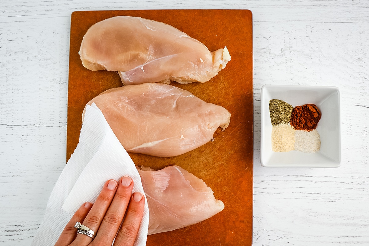 paper towel patting chicken dry