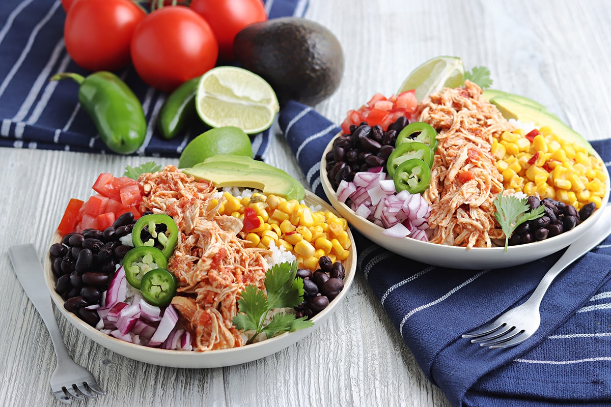 two plates of salsa chicken on a salad