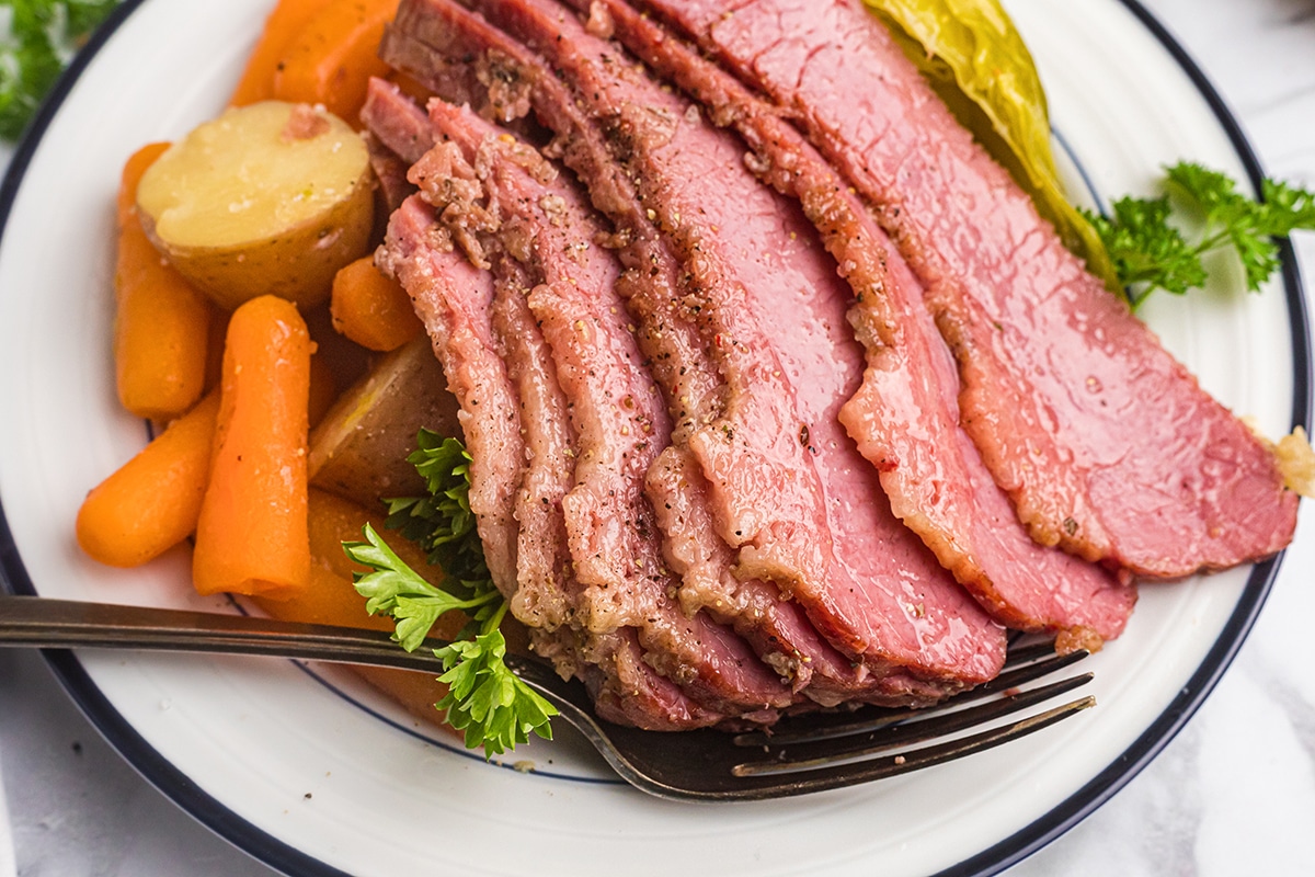 sliced corned beef with side on a plate