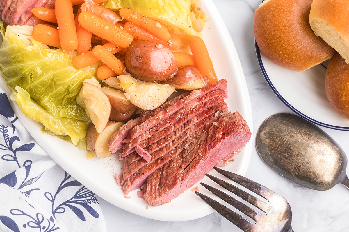 sliced cabbage on a serving platter with potatoes, carrots and cabbage