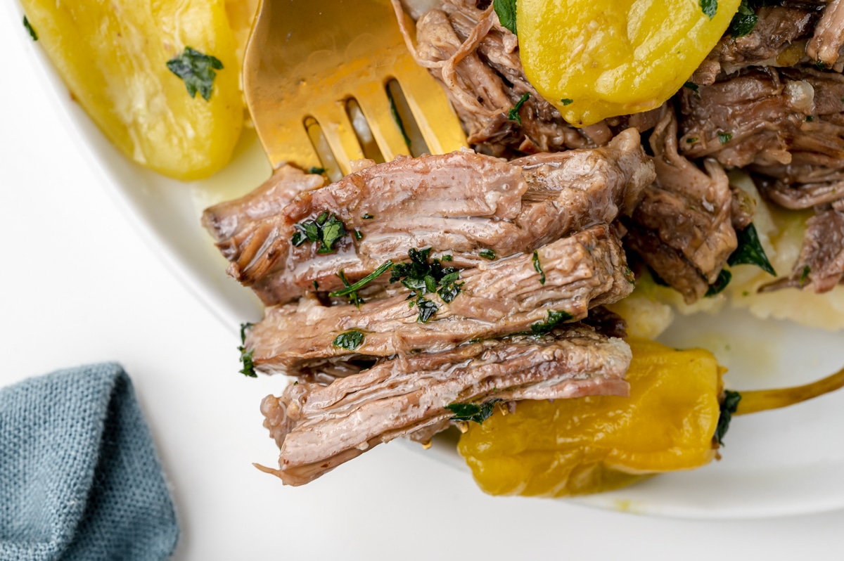 close up of bite of pot roast on a fork