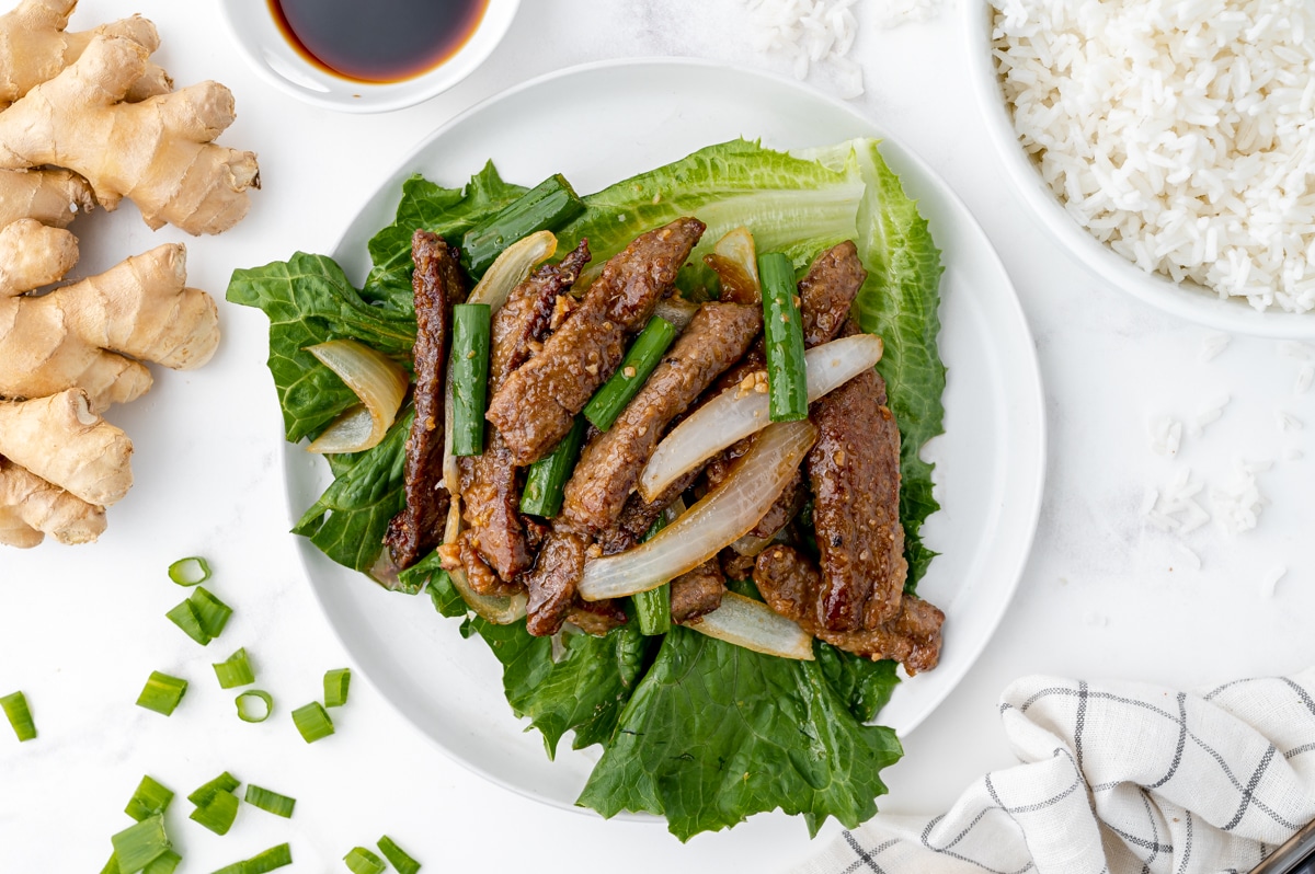 overhead shot of mongolian beef over lettuce