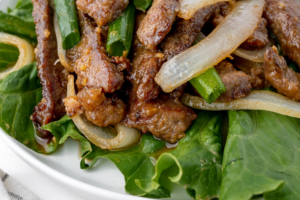 close up of mongolian beef over lettuce