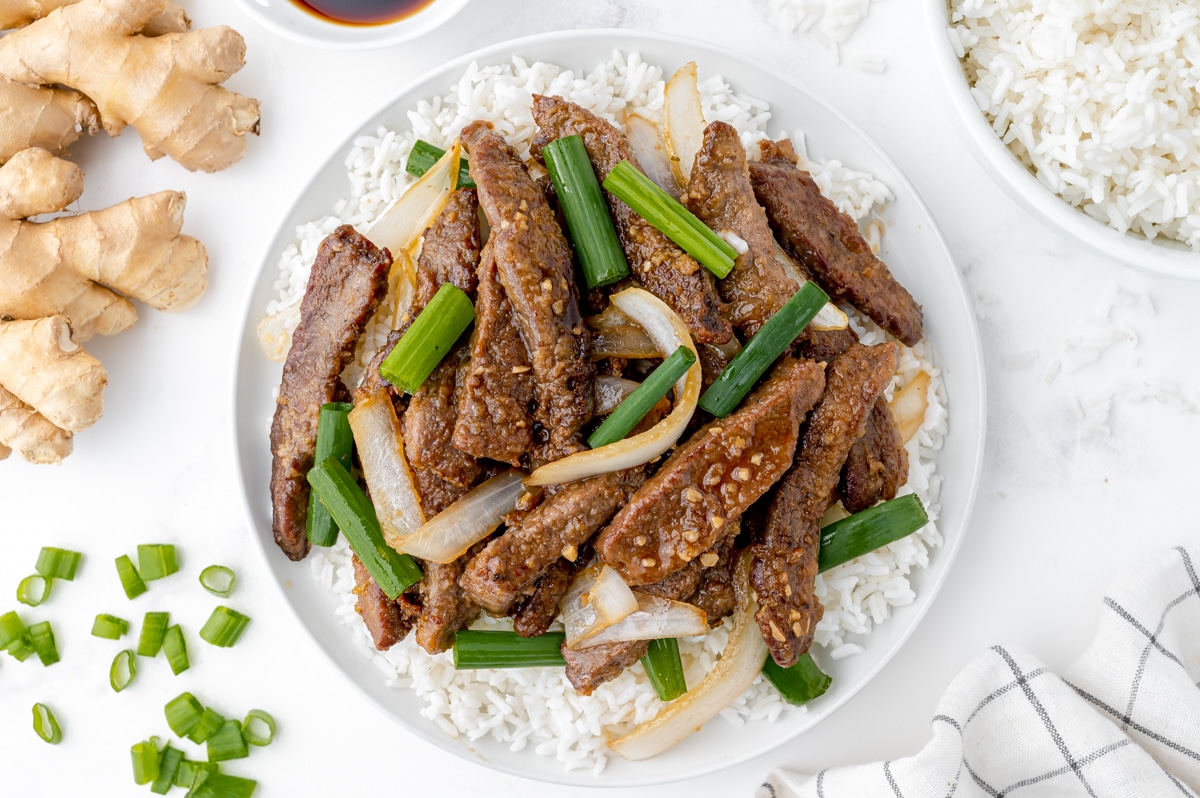 overhead shot of plate of stir fry beef over rice