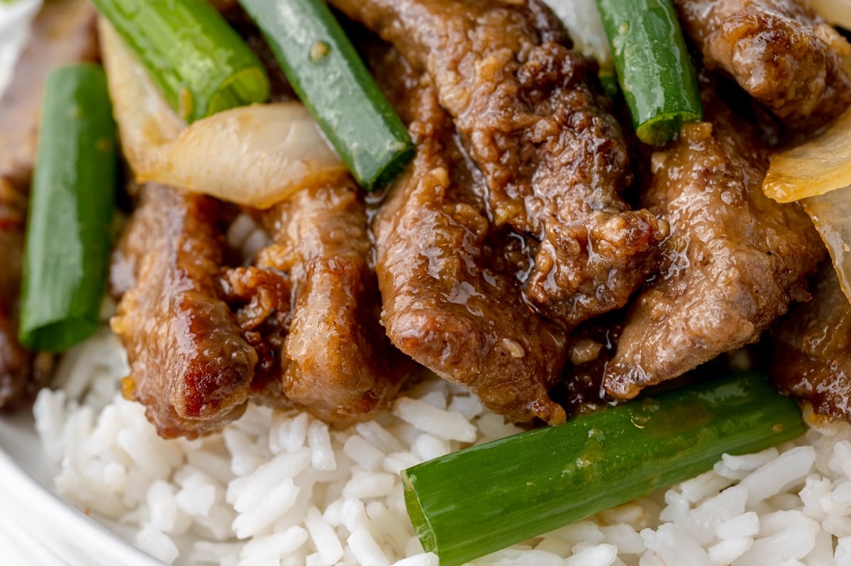 close up of stir fry beef over rice