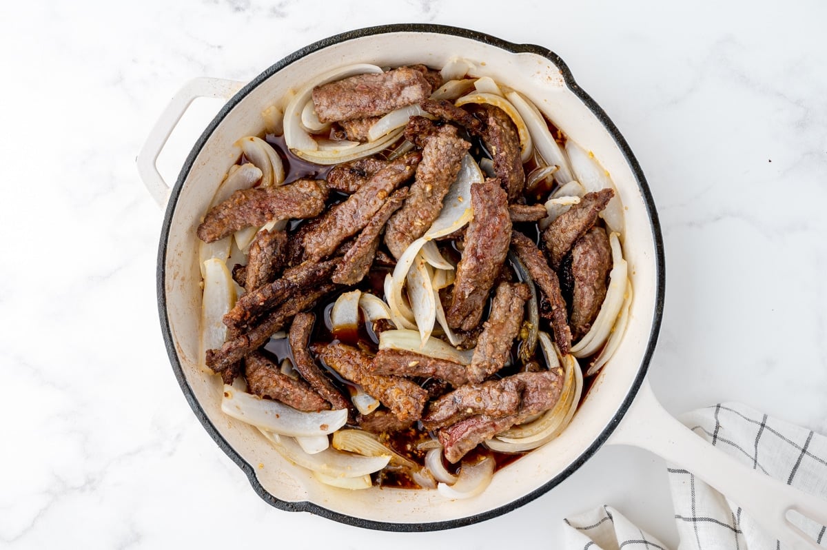 beef and onion cooking in a pan