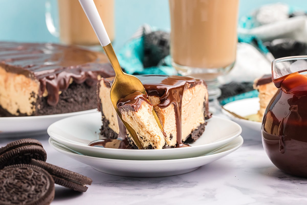 fork digging into slice of no bake peanut butter cheesecake