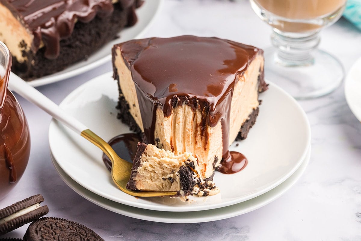 fork with bite taken out of slice of cheesecake