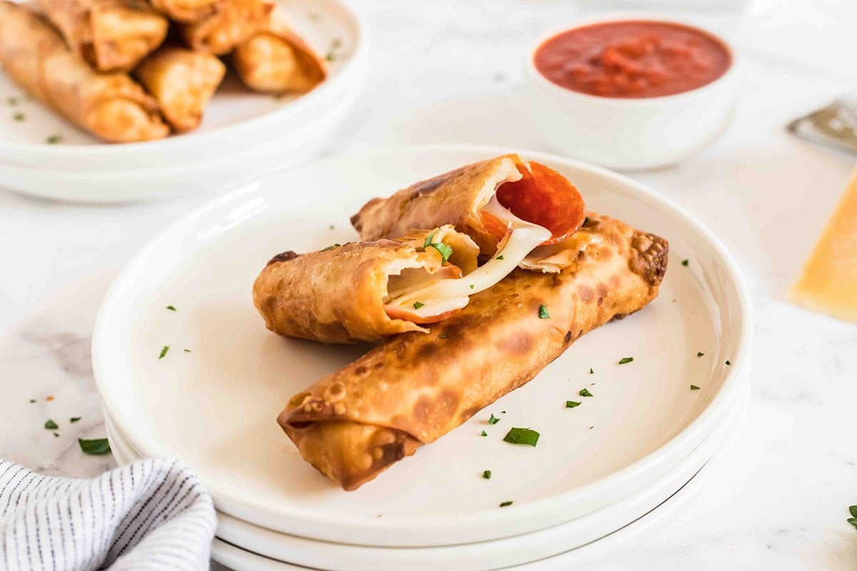 pizza roll cut in half on plate