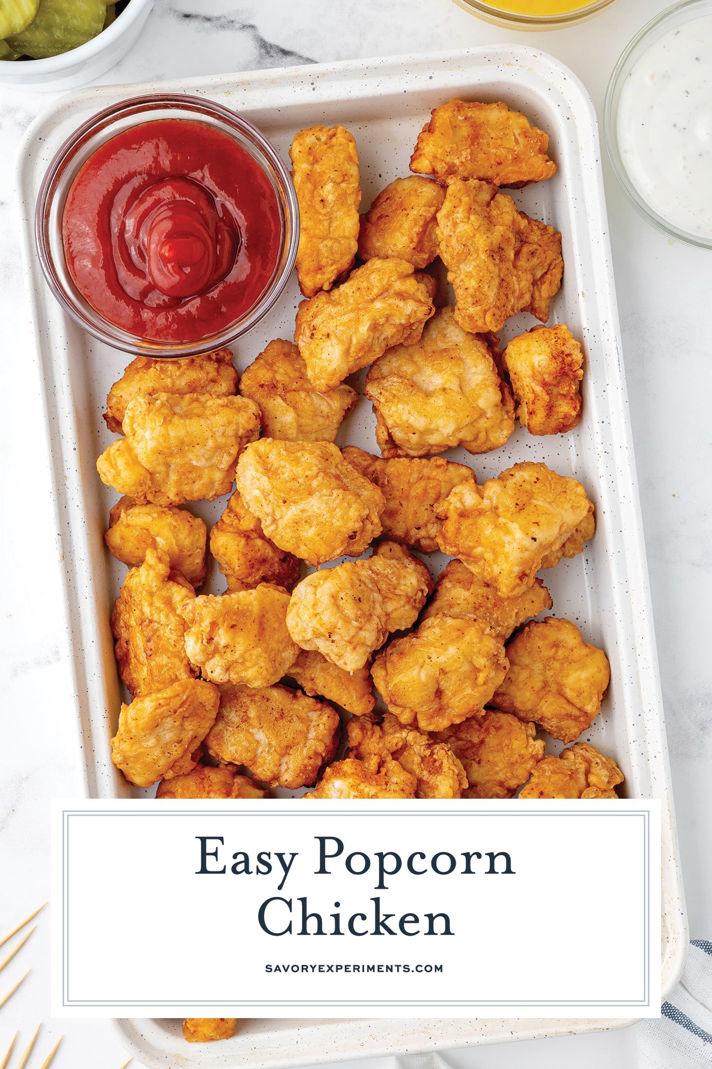 platter of popcorn chicken with text overlay for pinterest