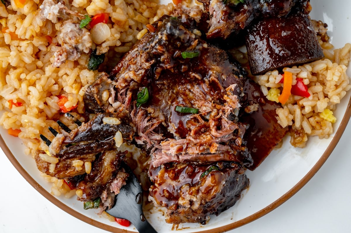 close up of short ribs on a plate with fried rice