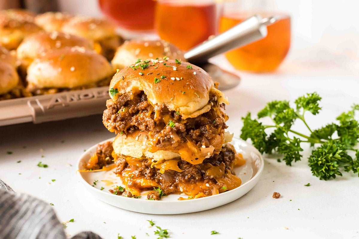 close up shot of two sloppy joe sliders on a plate