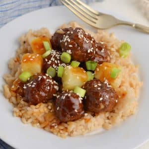 angled shot of bowl of teriyaki meatballs with rice