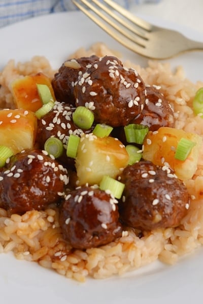 angled shot of bowl of teriyaki meatballs with rice
