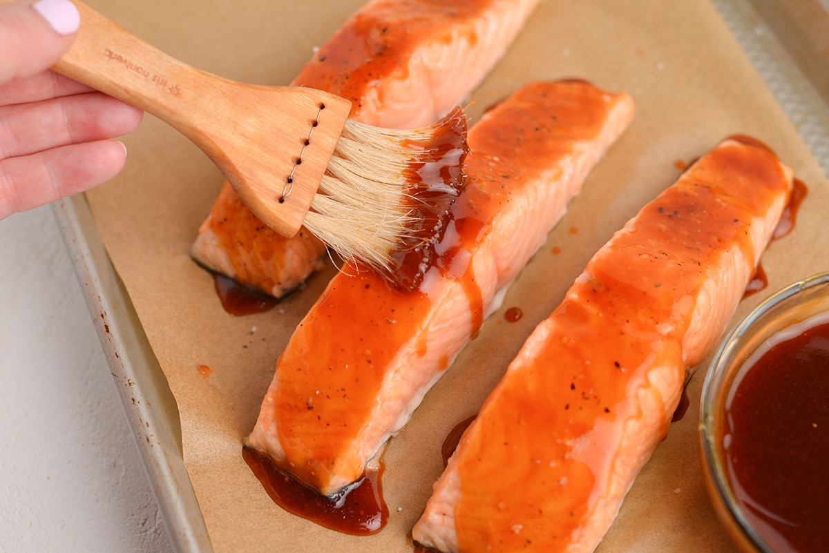 basting salmon fillets with teriyaki sauce