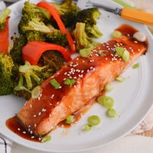 angle piece of teriyaki salmon with sesame seeds and scallions