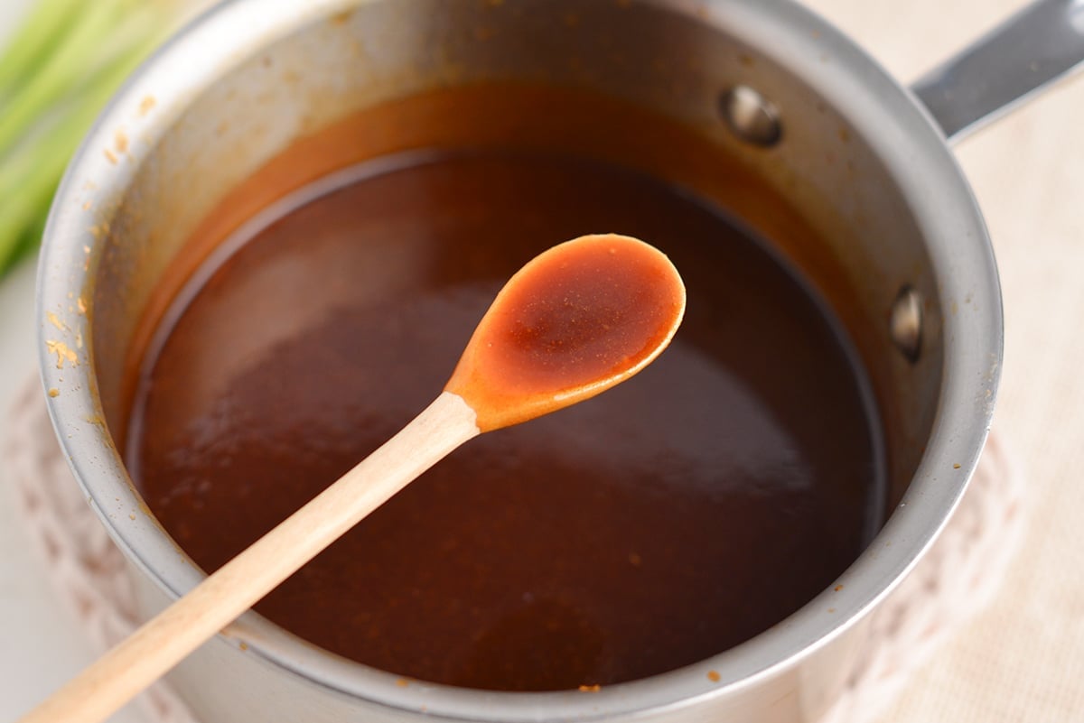 wooden spoon holding teriyaki sauce